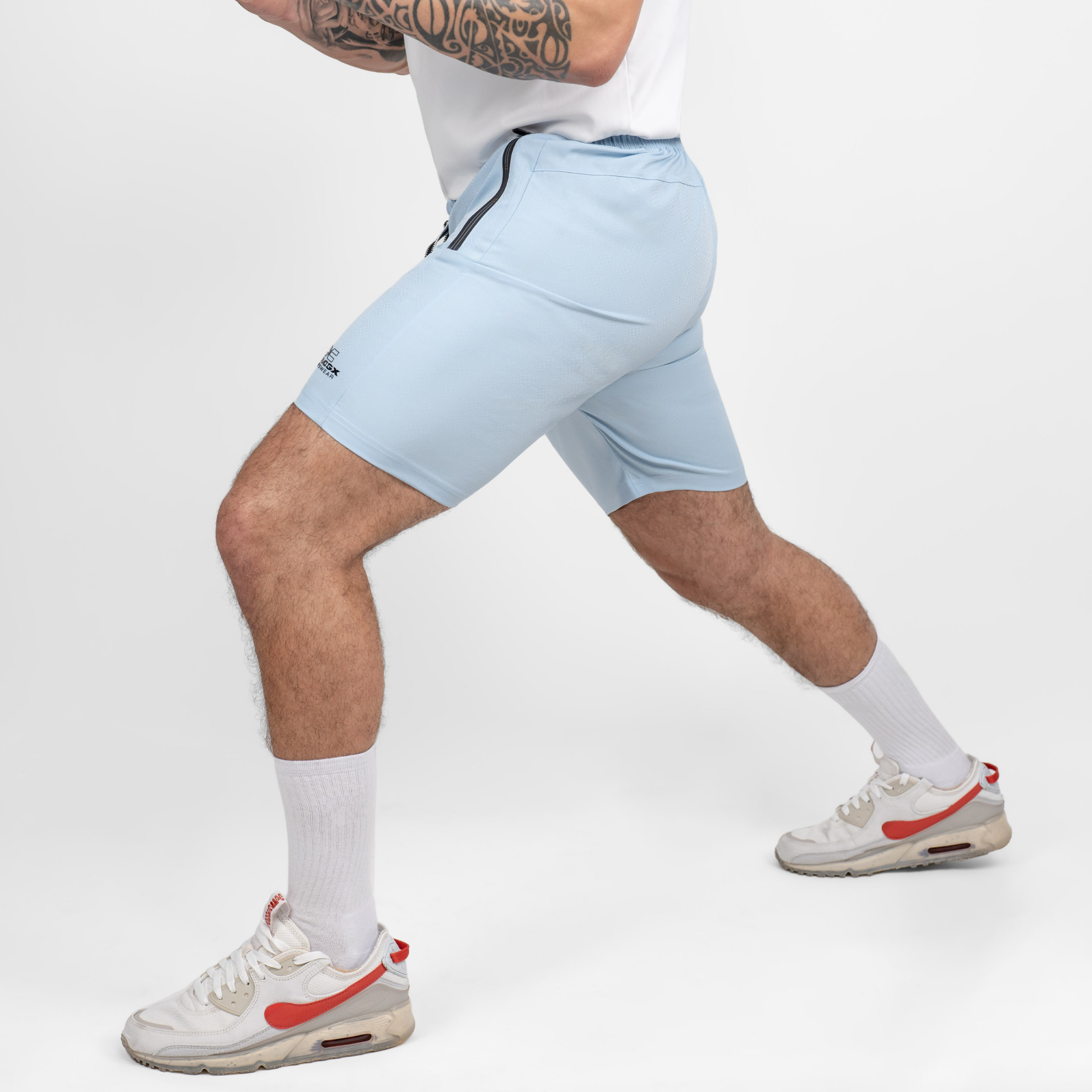 FFX Excellent Training Sport Shorts Flex Fit von FEFLOGX Sportswear, exzellente Sport Shorts, Kurze Sporthose, kurze Trainingshose, Sport Shorts Herren, kurze Jogginghose Herren in hellblau & hellgrün, seitliche Ansicht links vorne Action, hellblaue Sportshorts. FFX Excellent Training Sport Shorts Flex Fit